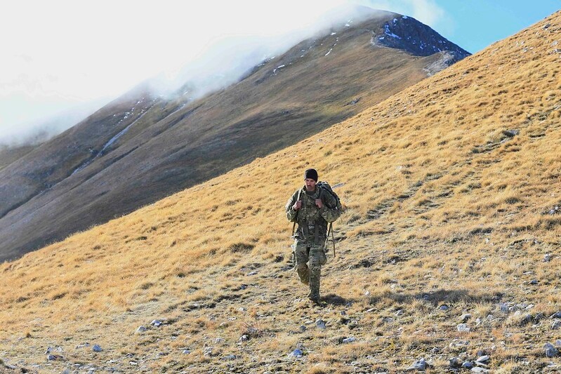 Soldier walking in grass