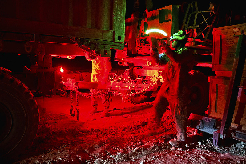 Soldier working with trucks at night